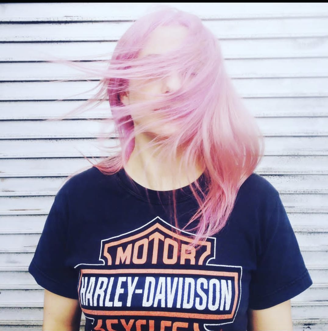 woman with pink hair swishing
