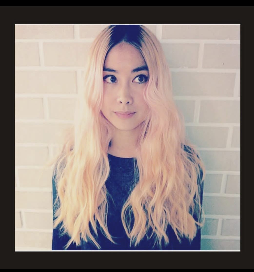 woman with long, wavy peach dyed hair